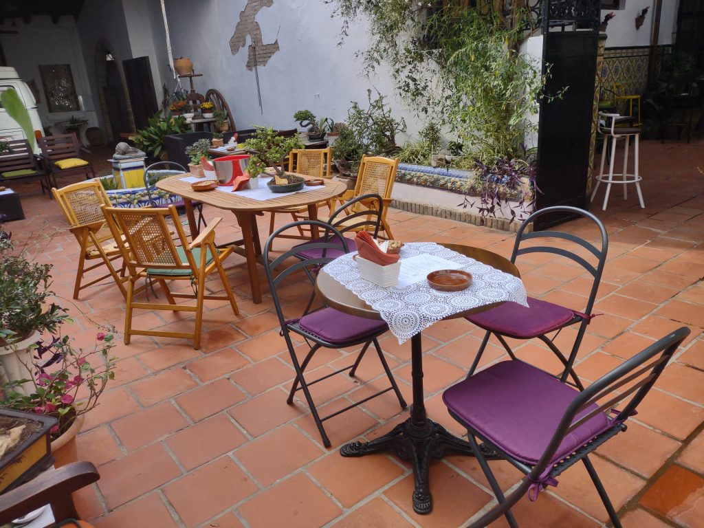Tables set in the patio of Casa Mayolica for a gathering