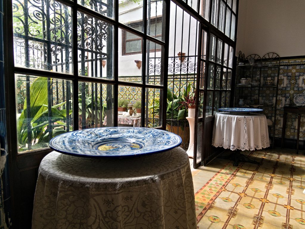 Blue ceramic plate displayed in the glass gallery of Casa Mayolica