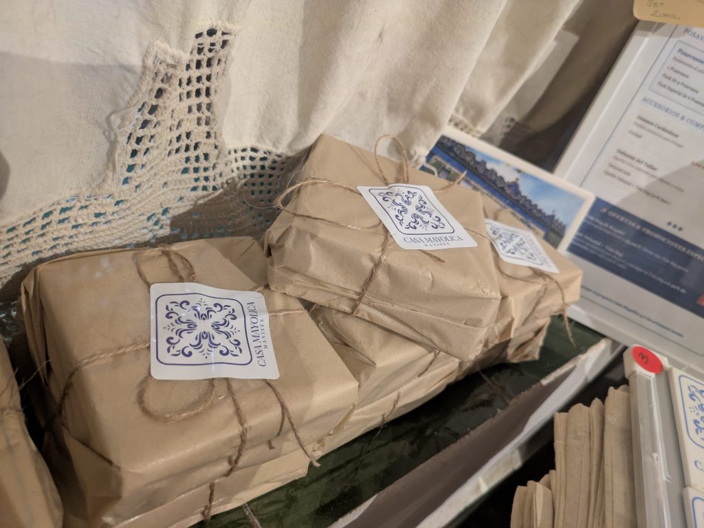 Small purchases from the Casa Mayolica ceramic market wrapped in brown kraft paper, tied with twine and sealed with Casa Mayolica Manises stickers